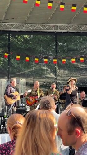 Belgian-flagged outdoor concert on a Kyiv lawn