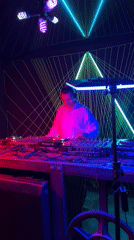 DJ performs at geometric-lit nightclub with laser light displays