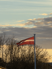 Girl with tissue, Latvian flag observed in Dreiliņi