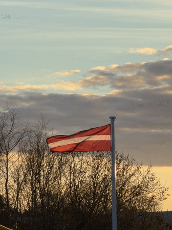 Girl with tissue, Latvian flag observed in Dreiliņi