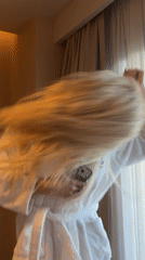 Woman dances with phone in Turkish hotel room