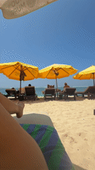 Woman sunbathes and takes selfies at Indonesian beaches