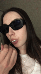 Woman photographed eating, posing indoors in Noviy, Russia