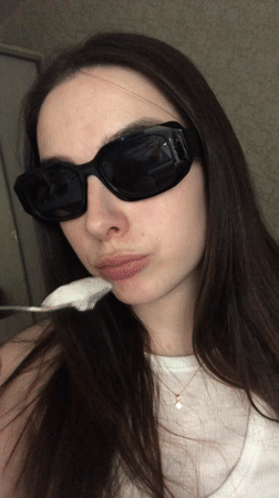 Woman photographed eating, posing indoors in Noviy, Russia