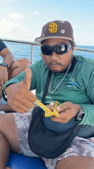 Person enjoys snack on boat in Indonesian waters