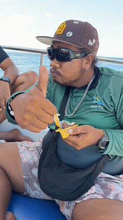 Person enjoys snack on boat in Indonesian waters