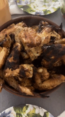 Dinner table with grilled wings and wine documented