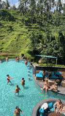 Resort guests enjoy pool activities amid Bali rice terraces