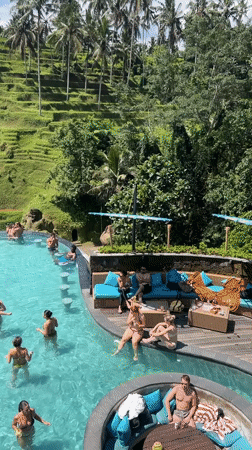 Resort guests enjoy pool activities amid Bali rice terraces