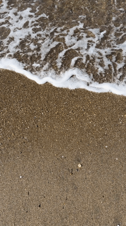 Waves and foam captured at Italian beach shoreline