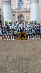 High school graduates pose with gold balloons in Birobidzhan