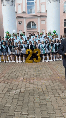 High school graduates pose with gold balloons in Birobidzhan