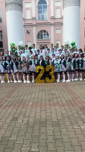 High school graduates pose with gold balloons in Birobidzhan