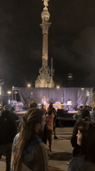 Nighttime outdoor concert draws crowds to urban plaza