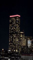 Late-night Midtown: glowing skyline and a Mr. Potato Head