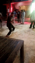Nighttime community celebration with dancing and games in Akwanga