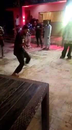Nighttime community celebration with dancing and games in Akwanga