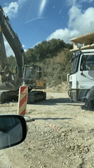 Construction workers direct traffic through active site in Montenegro