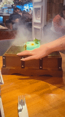London bartender serves theatrical green cocktail with smoking presentation