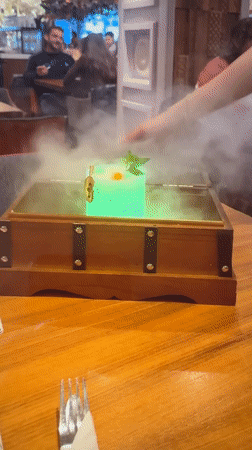 London bartender serves theatrical green cocktail with smoking presentation