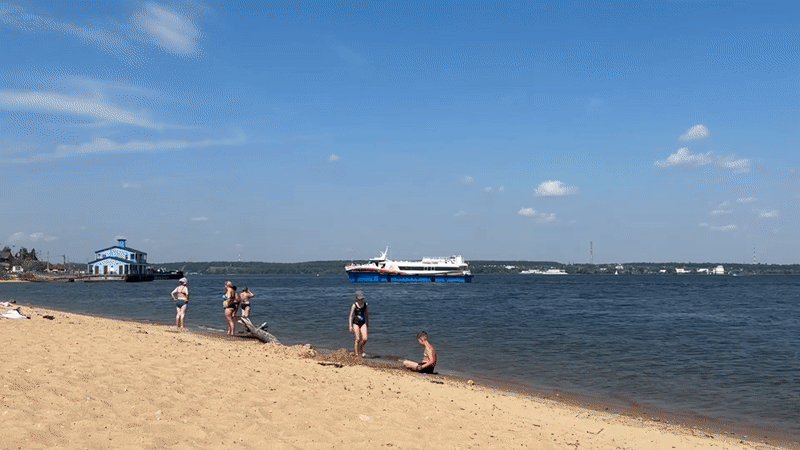 Beach day on the Volga with ferries passing close to shore