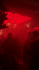 Moscow nightclub captured in atmospheric red lighting during evening hours
