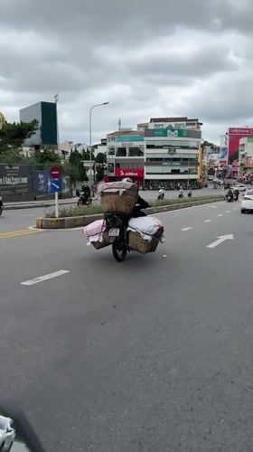 Motorcycle with cloth baskets spotted on Da Lat street