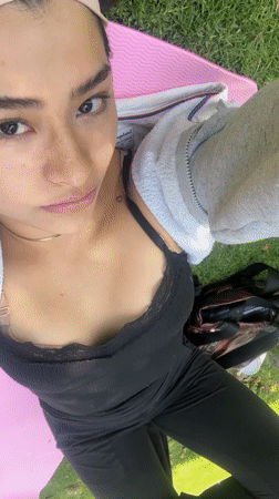 Two women relax on yoga mat in Puebla park