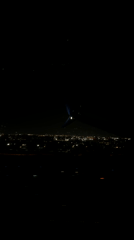 Nighttime aerial view of Miami captured from airplane window