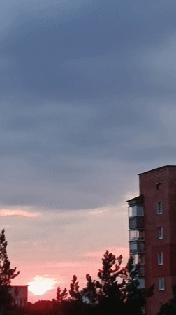 Midsummer twilight over Svietlahorsk's pine-ringed apartment blocks