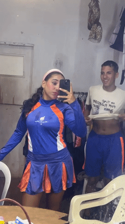Woman takes selfies in cheerleader outfit around Porlamar, Venezuela