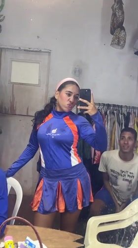 Woman takes selfies in cheerleader outfit around Porlamar, Venezuela