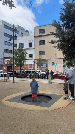 Child plays on trampoline at Barcelona park