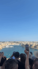 Tourists explore historic Valletta landmarks during busy afternoon