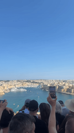 Tourists explore historic Valletta landmarks during busy afternoon