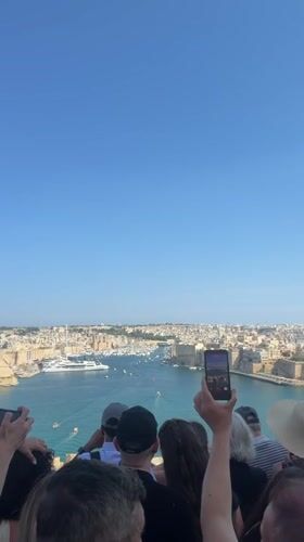 Tourists explore historic Valletta landmarks during busy afternoon