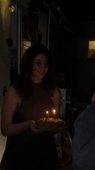 Woman celebrates 23rd birthday with cake outdoors in Sofia