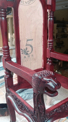 Ornate red throne chair displayed outside Puttaparthi furniture shop