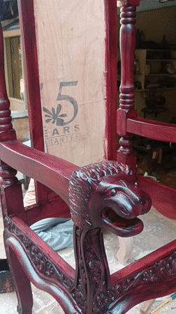 Ornate red throne chair displayed outside Puttaparthi furniture shop