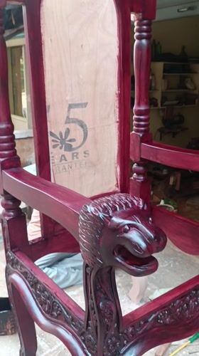 Ornate red throne chair displayed outside Puttaparthi furniture shop