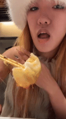 Woman eats dumplings in winter clothing in Shibuya