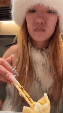 Woman eats dumplings in winter clothing in Shibuya