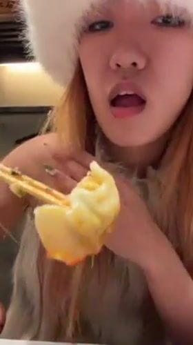Woman eats dumplings in winter clothing in Shibuya