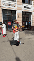 Morning street life captured in Заволжье: busker, families, statues