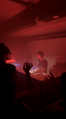 DJ performs at dimly lit Paris club