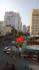 Observer documents Nha Trang street life and flora from elevated view