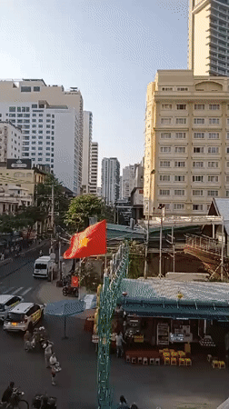 Observer documents Nha Trang street life and flora from elevated view