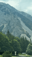 Driving past a rugged scree slope in Tržič, Slovenia