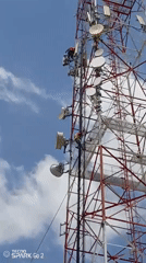 Telecom workers install equipment on tower in Tinaquillo, Venezuela
