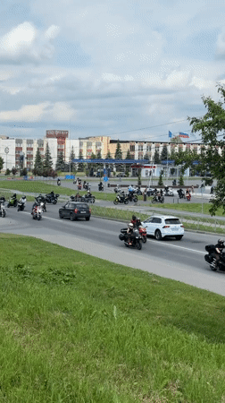 Tourist documents peony blooms at historic Novgorod churches